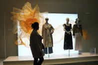 A shopper walks past a window display for an apparel store in Shanghai on March 18, 2024. (AP Photo/Ng Han Guan)