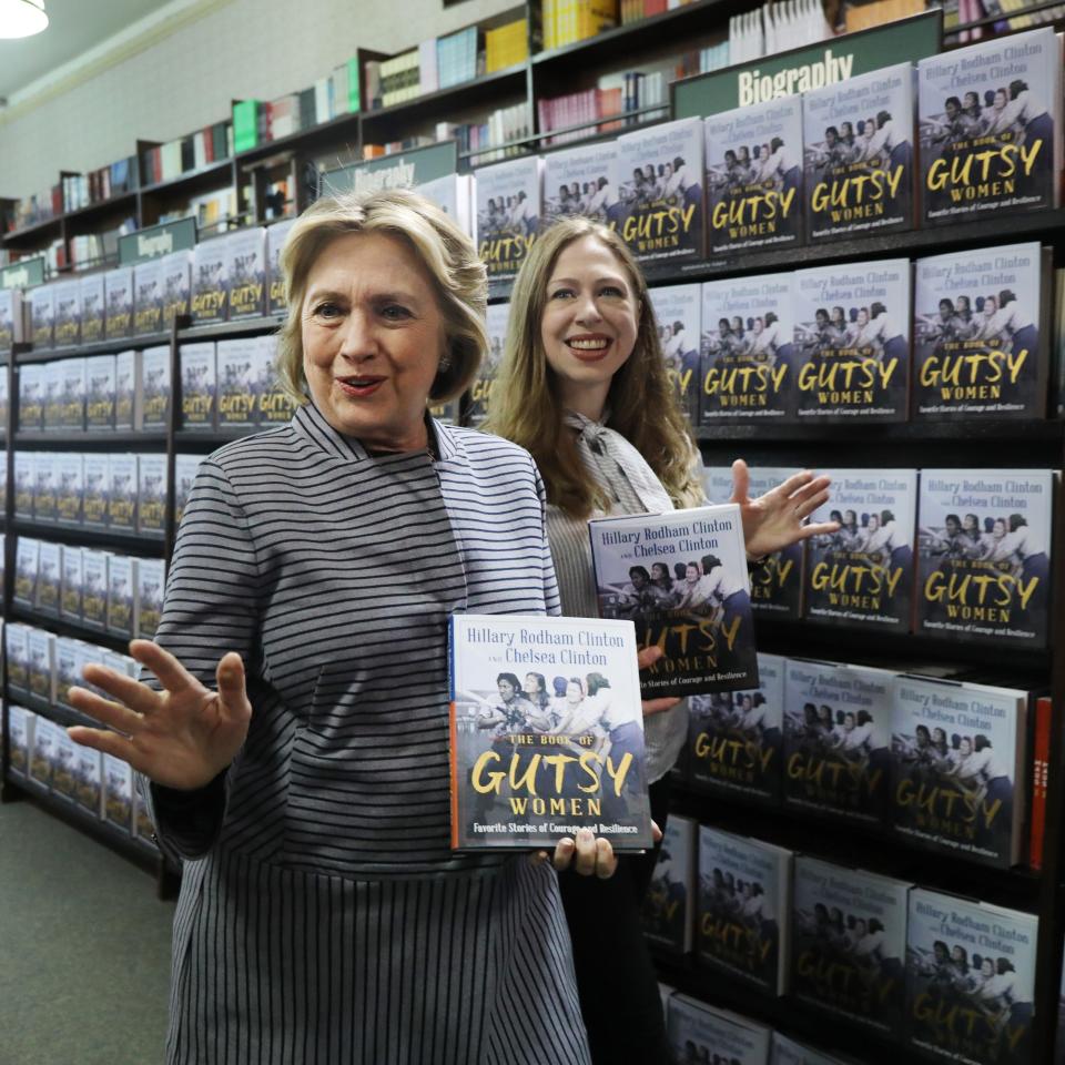 Chelsea and Hillary Clinton pose with their new book "The Book of Gutsy Women" on October 03, 2019 in New York City.