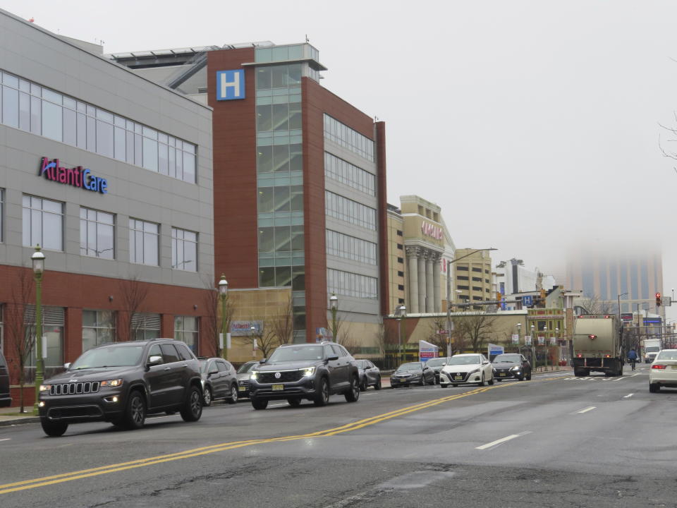 Cars drive along Atlantic Avenue in Atlantic City, N.J. on Jan. 26, 20245 past the AtlanticCare hospital and Caesars casino. Both those entities wanted a judge to block the city's plan to reduce the width of the street, the main artery through Atlantic City's downtown, from four lanes to two. But on Jan. 24, 2024 the judge refused to do so. (AP Photo/Wayne Parry)