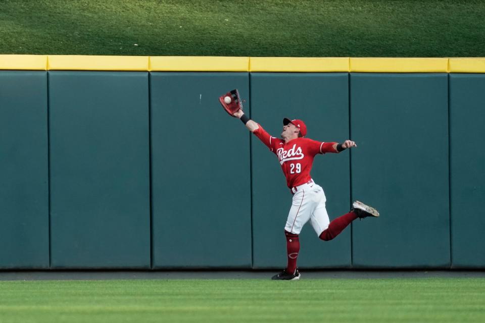 Cincinnati Reds center fielder TJ Friedl stretches to catch a fly ball hit by Chicago Cubs' Yan Gomes during the second inning of a baseball game Saturday, Sept. 2, 2023, in Cincinnati.