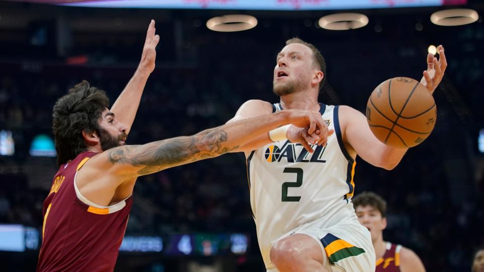 Utah Jazz's Joe Ingles (2) loses control of the ball against Cleveland Cavaliers' Ricky Rubio, left, in the first half of an NBA basketball game, Sunday, Dec. 5, 2021, in Cleveland. (AP Photo/Tony Dejak)