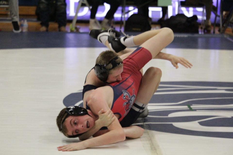 Gulf Breeze's Gavin Samons (top) tries to roll over Fort Walton Beach's Isaac Vosburgh during the 115-pound weight class battle in the District 1-2A Duals Tournament first-place matchup at Gulf Breeze High School on Wednesday, Jan. 3, 2024.