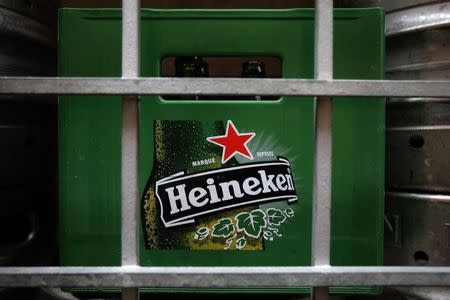 A plastic container with empty bottles of Heineken beers are pictured among beer kegs outside a restaurant in Singapore August 29, 2012. REUTERS/Tim Chong