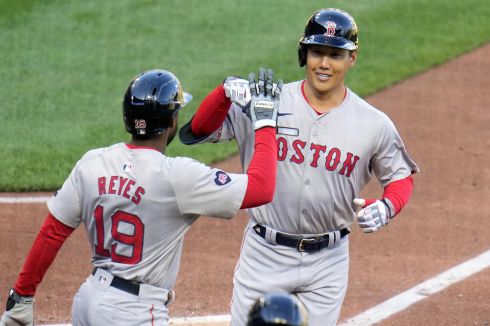 Boston Red Sox's Masataka Yoshida, right, is greeted by Pablo Reyes as he heads to the dugout after hitting a two-run home run off Pittsburgh Pirates starting pitcher Mitch Keller during the sixth inning of a baseball game in Pittsburgh, Saturday, April 20, 2024. (AP Photo/Gene J. Puskar)