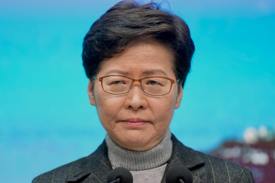 Hong Kong Chief Executive Carrie Lam listens to a reporter's question during a news conference where she spoke of Secretary of Home Affairs Caspar Tsui's resignation in Hong Kong, Monday, Jan. 31, 2022. Tsui resigned Monday for attending a birthday party with about 200 guests in early January as the city was battling a coronavirus surge. At least one guests later tested positive, and Secretary of Home Affairs Caspar Tsui was among several officials and lawmakers ordered to quarantine after the party, which was held for Witman Hung, a delegate to China's legislature. (AP Photo/Vincent Yu)