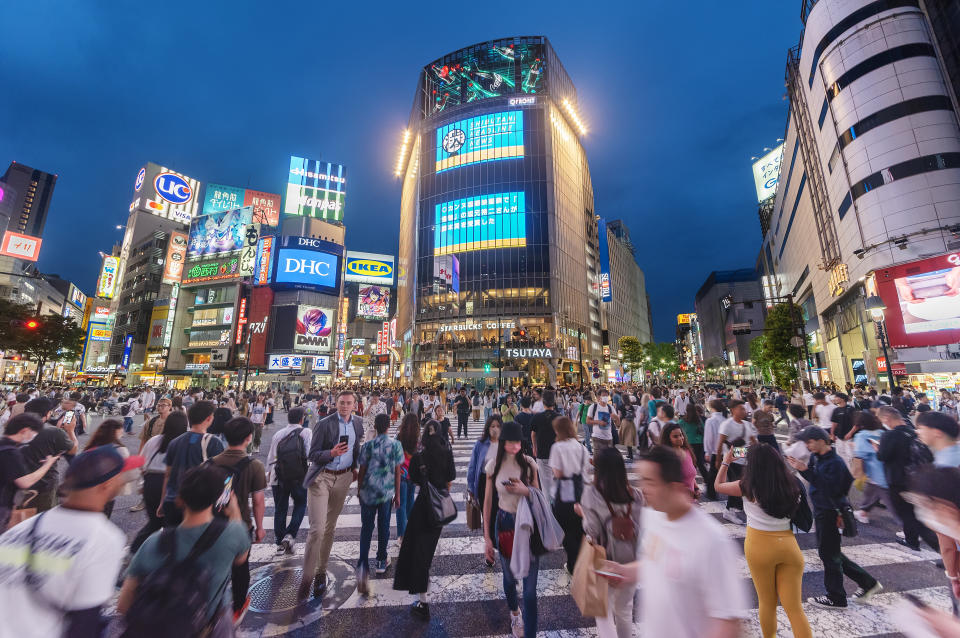 Tokyo, Japan - May 28, 2023 : Crowds crossing Shibuya scramble crossing, the famous intersection in Tokyo outside Shibuya station at night