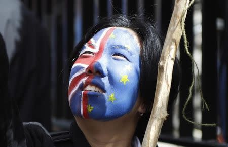 A woman looks upwards during a 'March for Europe' demonstration against Britain's decision to leave the European Union, in central London, Britain July 2, 2016. Britain voted to leave the European Union in the EU Brexit referendum. REUTERS/Tom Jacobs