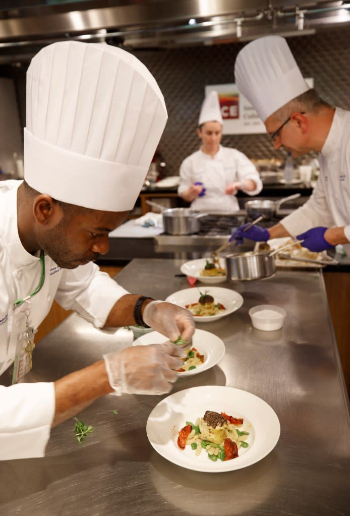 Sous chefs plating Walker’s monkfish dish. Tamara Beckwith