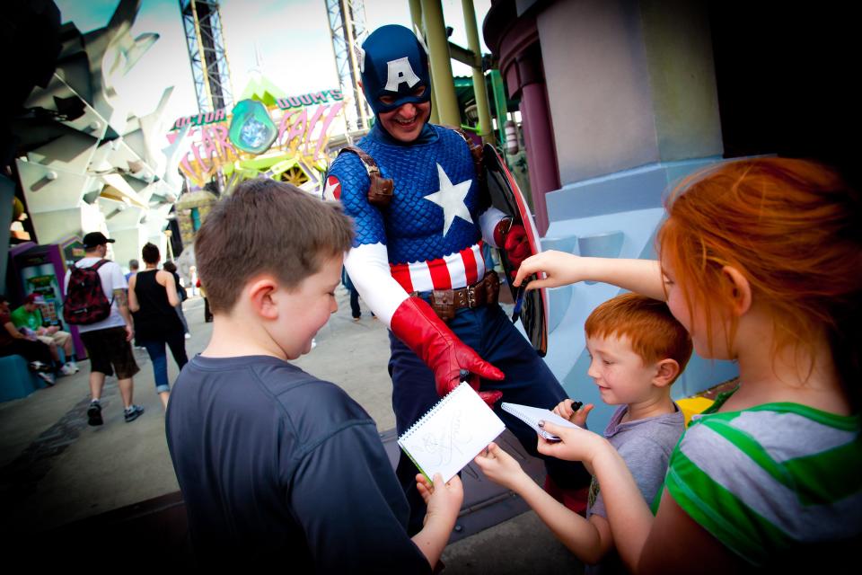 Pre-COVID, children at Universal Orlando’s Islands of Adventure got Captain America’s autograph. Now such encounters are socially distanced or off-limits.