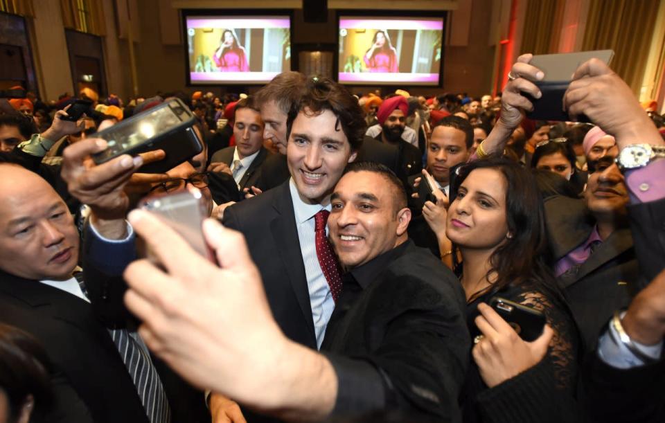 Prime Minister Justin Trudeau is surrounded by guests at the Vaisakhi Celebration on Parliament Hill on Monday, April 11, 2016 in Ottawa. THE CANADIAN PRESS/Justin Tang