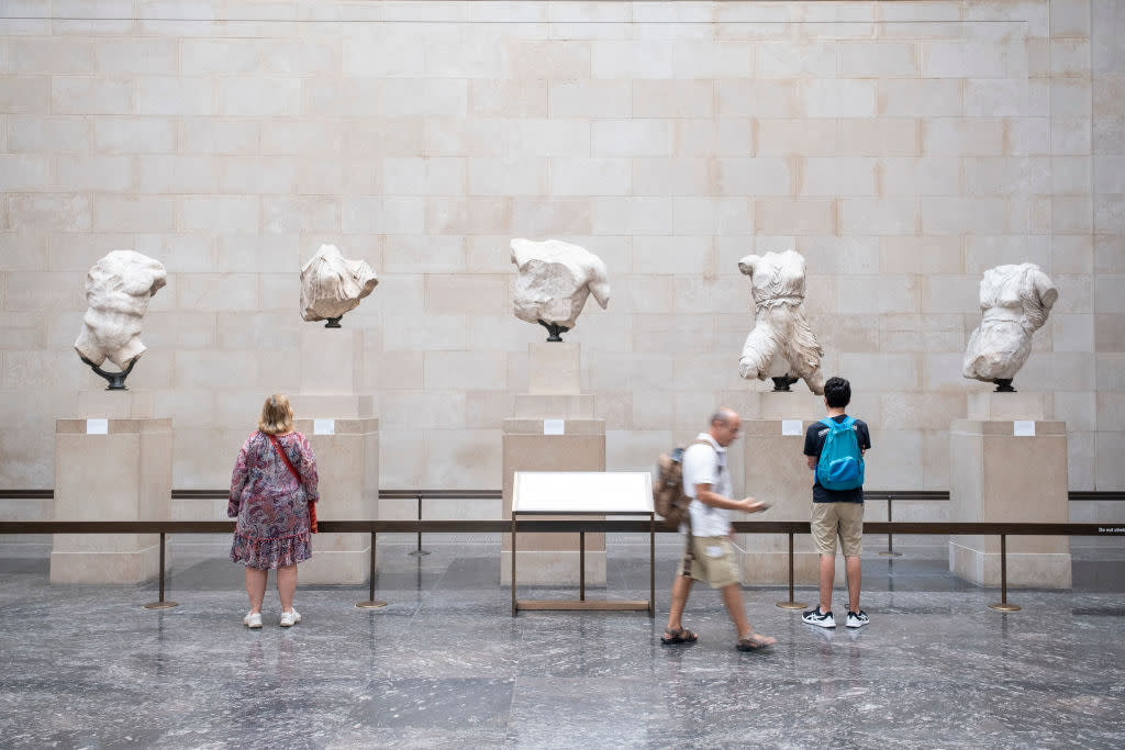  Tourists visit the Elgin Marbles at the British Museum in London. 