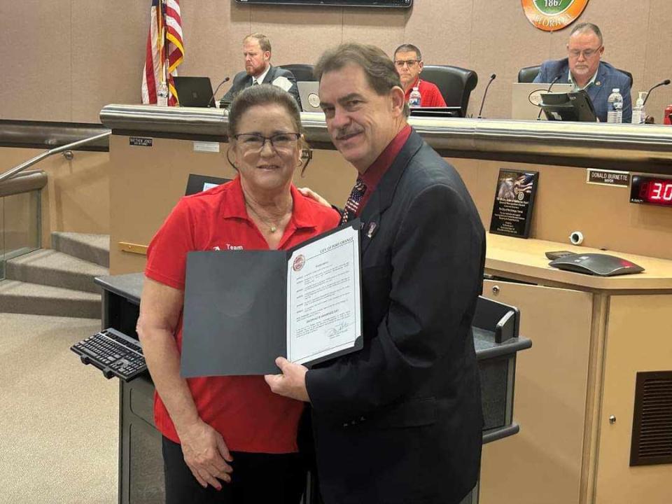Kat Atwood, a former Port Orange City Council member, poses with Mayor Don Burnette after the city read a proclamation designating Thursday, Feb. 22, as World Encephalitis Day.