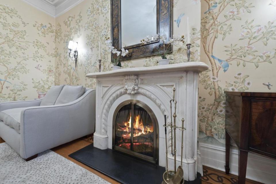 A woodburning fireplace with an 18th-century marble mantel. Concierge Auctions