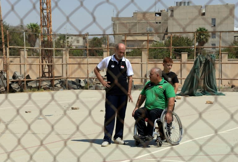 Iraqi weightlifting trainer Tamer Ghanem (L) says he hopes improvements in security will soon permit new training equipment to arrive in Mosul