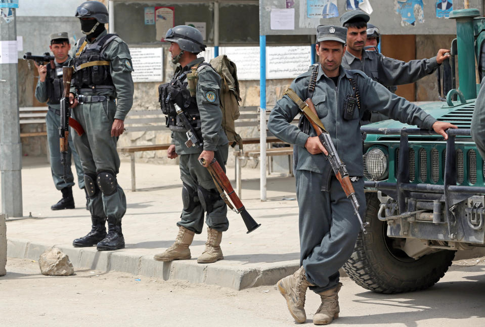 Afghan police forces stand guard in front of the main gate of Cure International Hospital in Kabul, Afghanistan, Thursday, April 24, 2014. (AP Photo/Massoud Hossaini)