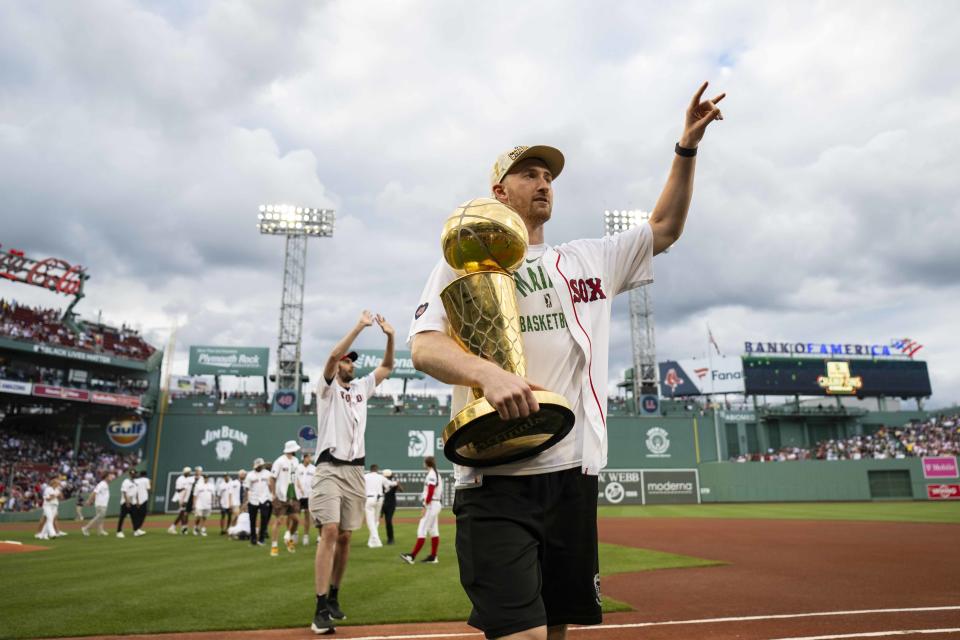 BOSTON, MA - JUNE 24: Sam Hauser #30 of the Boston Celtics holds the Larry O'Brien Championship trophy during a pre-game ceremony recognizing the NBA Finals Championship before a game between the Boston Red Sox and Toronto Blue Jays on June 24, 2024 at Fenway Park in Boston, Massachusetts.  (Photo by Billie Weiss/Boston Red Sox/Getty Images)