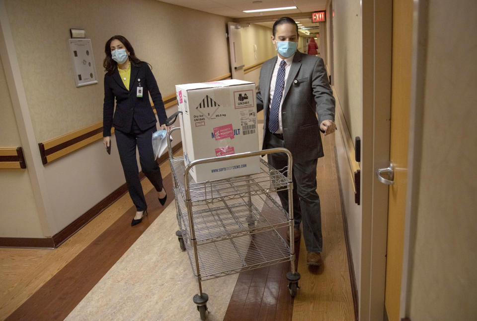 Nancy Palamara and Joseph Cruz accepted the vaccine and stored it in the 80 degree below zero freezer. (Jeff Rhode/Holy Name Medical Center)