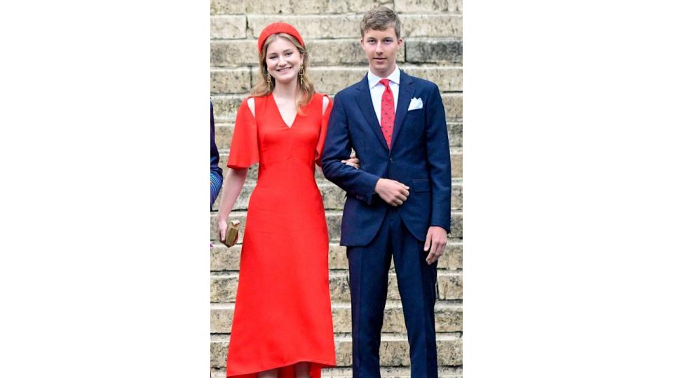 Princess Elisabeth in a red cut-out dress with Prince Emmanuel