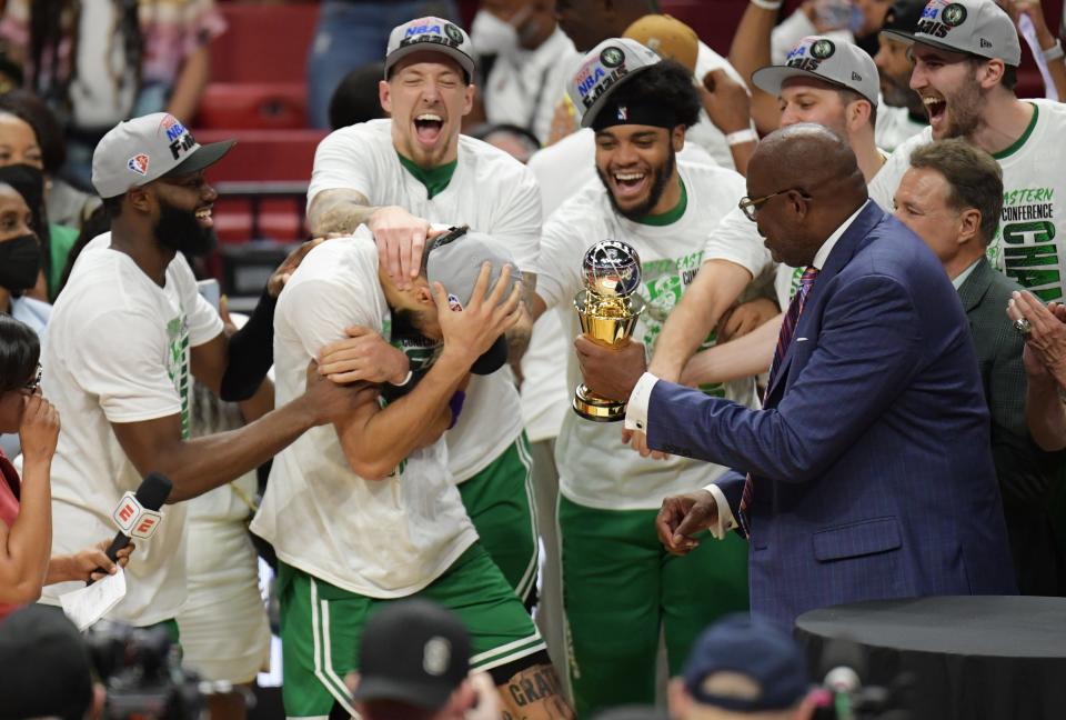 Boston Celtics forward Jayson Tatum (0) and teammates react after Tatum won the Larry Bird Eastern Conference Finals MVP trophy.