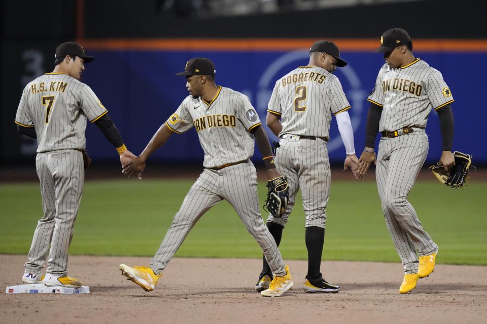 San Diego Padres' Ha-Seong Kim (7) and Xander Bogaerts (2) celebrate with teammates after a baseball game against the New York Mets Tuesday, April 11, 2023, in New York.(AP Photo/Frank Franklin II)