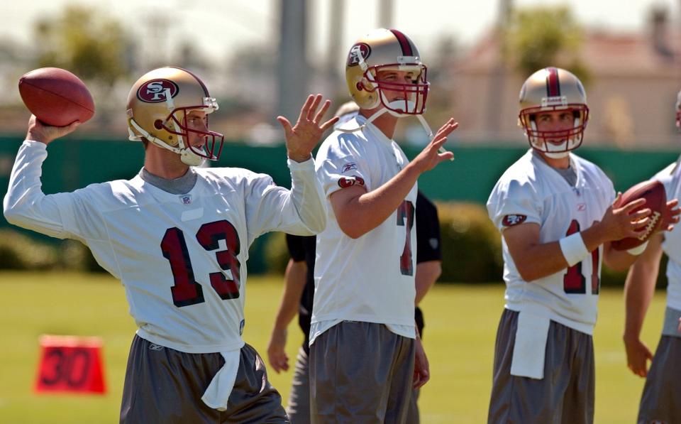 San Francisco 49ers quarterbacks, from left, Tim Rattay, Ken Dorsey and Brandon Doman throw during practice at the 49ers’ training camp in Santa Clara, Calif., Friday, July 30, 2004. | Paul Sakuma, Associated Press