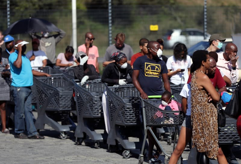 Shoppers queue to stock up on groceries at a Pick n Pay store