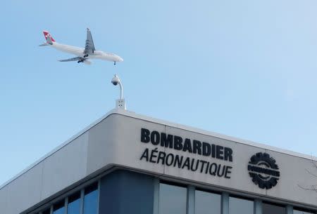 FILE PHOTO - A plane flies over a Bombardier plant in Montreal, Quebec, Canada on January 21, 2014. REUTERS/Christinne Muschi/File Photo