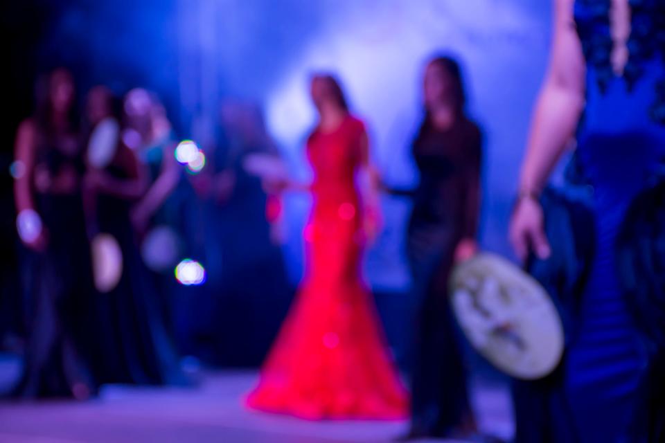 Beauty pageant blurry background red dress