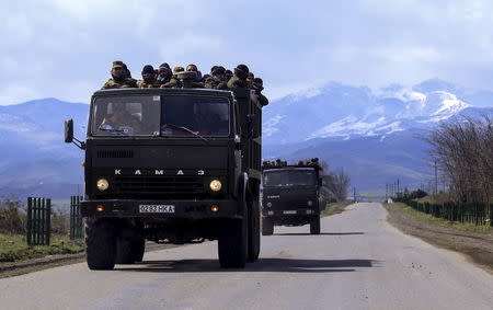 Volunteers drive trucks in the direction towards the frontline to join the self-defense army of Nagorno-Karabakh on a road in the breakaway Nagorno-Karabakh region, April 4, 2016. REUTERS/Hrayr Badalyan/PAN Photo