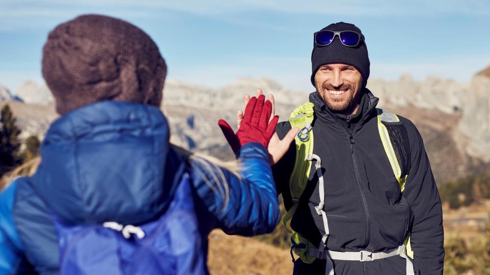 Man and woman high-fiving during hike