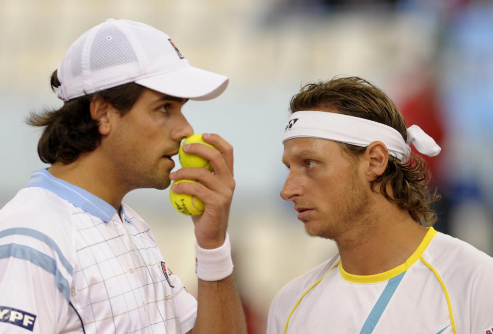 Argentina's David Nalbandian (R) and Eduardo Schwank (L) react during the Davis Cup final doubles match against Spain's Fernando Verdasco and Feliciano Lopez  at La Cartuja Olympic stadium in Sevilla on December 3, 2011.   AFP PHOTO / CRISTINA QUICLER (Photo credit should read CRISTINA QUICLER/AFP/Getty Images)