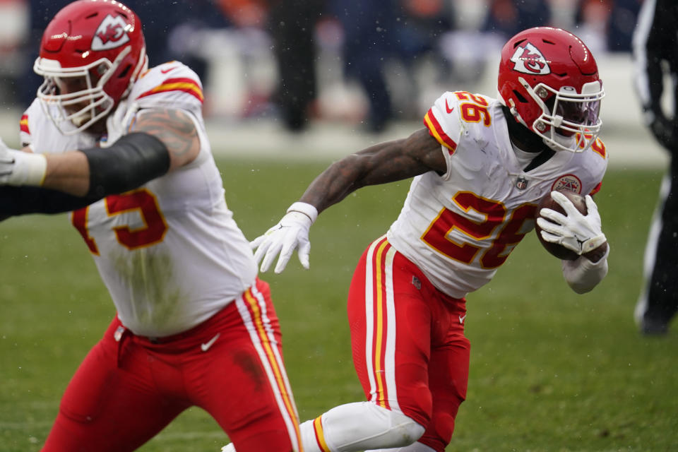 Kansas City Chiefs running back Le'Veon Bell, right, runs with the ball during the second half of an NFL football game against the Denver Broncos, Sunday, Oct. 25, 2020, in Denver. (AP Photo/David Zalubowski)