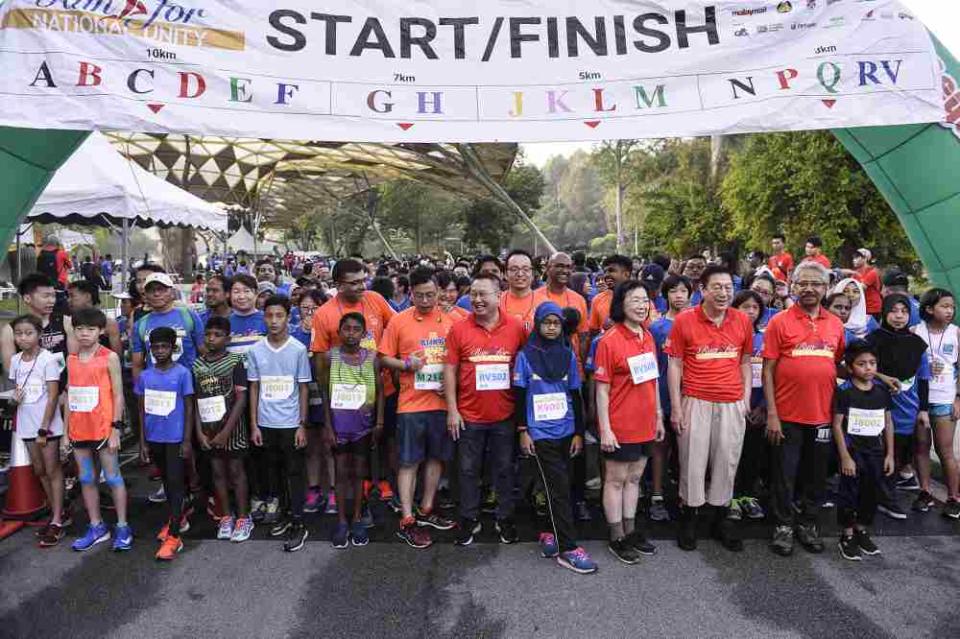 Minister in Prime Minister's Department in charge of National Unity and Social Well-being Senator P. Waytha Moorthy (second right) and other VIPs pose for a photo with the runners during the Run For National Unity 2019 event in Kuala Lumpur October 5, 2019.