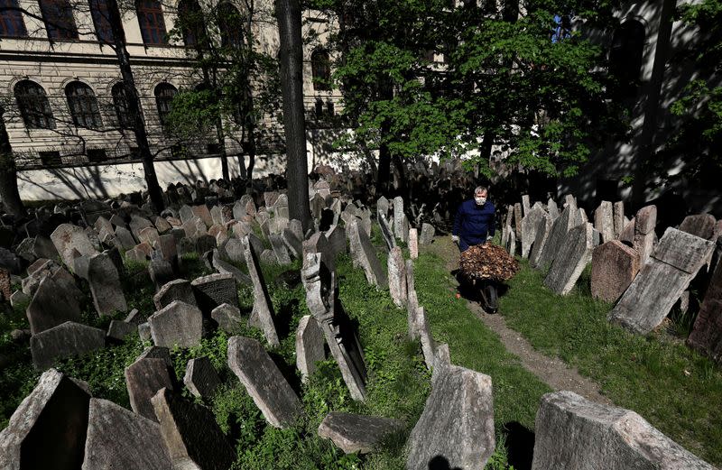 A gardener works at the Old Jewish Cemetery in Prague