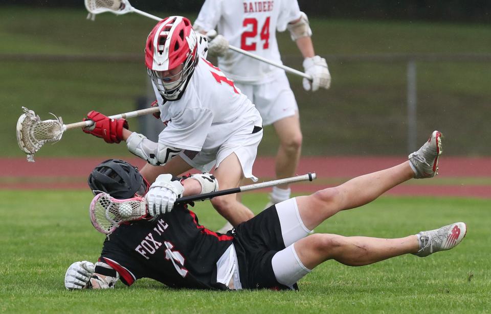 North Rockland's Montana Veit (11) puts pressure on Fox Lane's Will Shepherd (16) during boys lacrosse playoff action at North Rockland High School in Thiells May 20, 2022. North Rockland won the game 10-0.