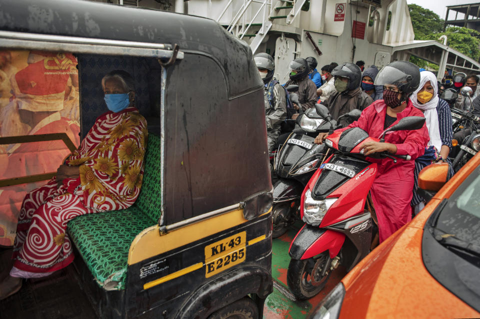 Commuters wearing masks as a precaution against the coronavirus travel in a ferry in Kochi, Kerala state, India, Monday, June 22 2020. India is the fourth hardest-hit country by the COVID-19 pandemic in the world after the U.S., Russia and Brazil. (AP Photo/R S Iyer)