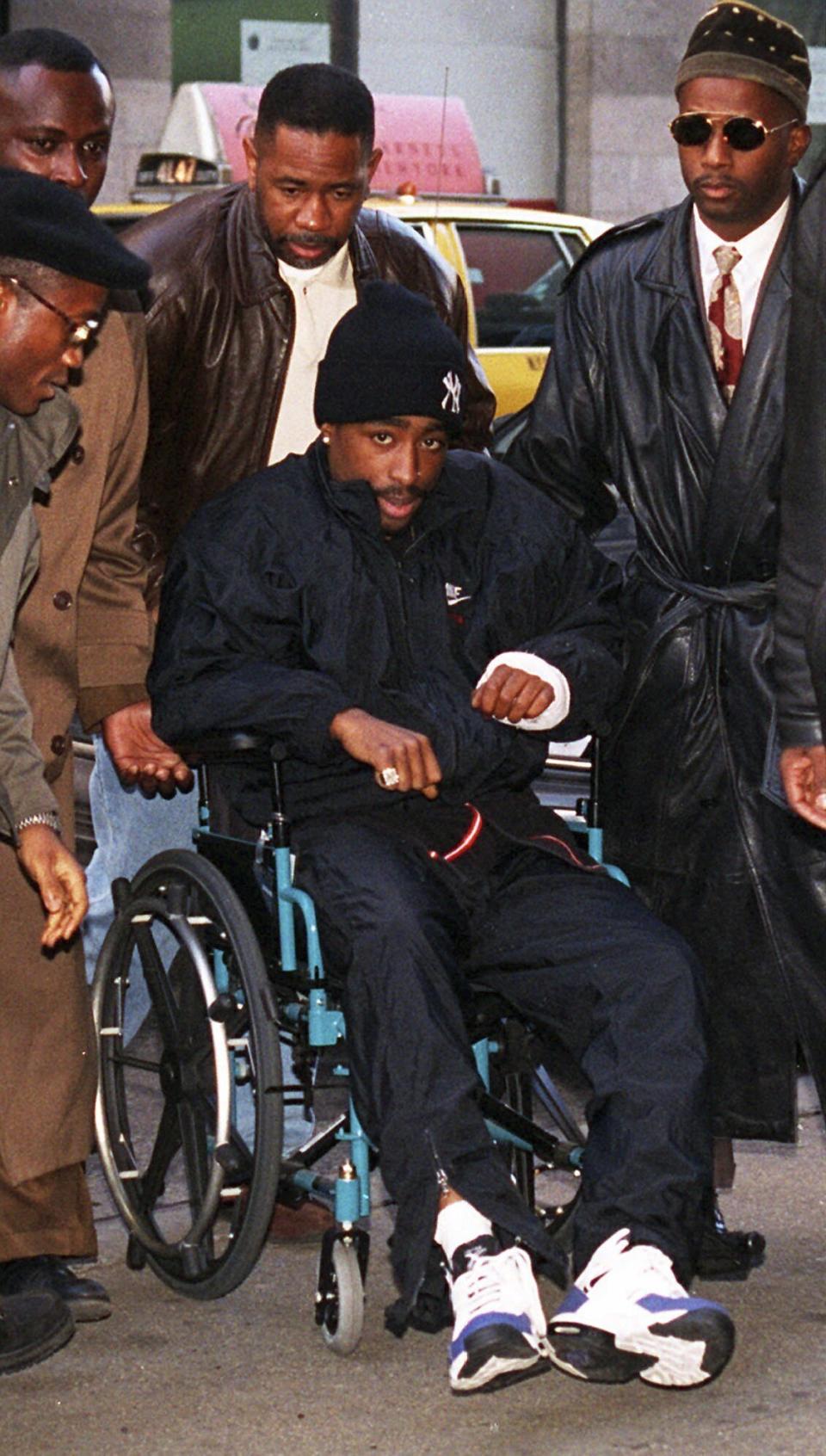 FILE - Rapper Tupac Shakur arrives at Manhattan Supreme Court in New York on Dec. 1, 1994, after being injured in a shooting. Less than 24 hours after the shooting, Shakur made a court appearance in a wheelchair on sex-assault charges against him. Tupac Shakur’s shooting in a New York recording studio in the mid-1990s sparked hip-hop’s biggest rivalry and led to the shocking deaths of two of the genre's greatest stars, Shakur, and Notorious B.I.G. (AP Photo/Eric Miller, File)