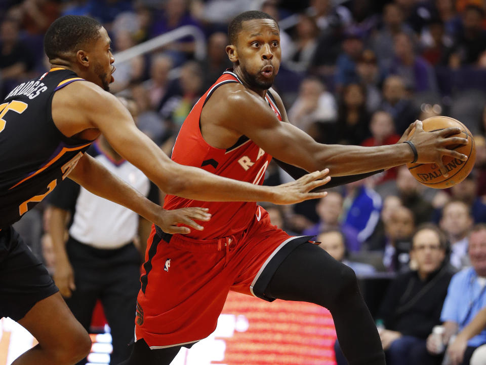 Toronto Raptors forward CJ Miles, right, drives past Phoenix Suns forward Mikal Bridges defends during the first half of an NBA basketball game, Friday, Nov. 2, 2018, in Phoenix. (AP Photo/Matt York)