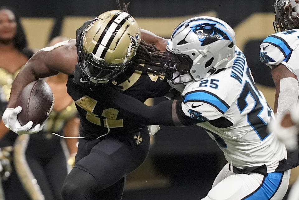 New Orleans Saints running back Alvin Kamara (41) runs the ball against Carolina Panthers safety Xavier Woods (25) during the second half of an NFL football game Sunday, Sept. 8, 2024, in New Orleans. (AP Photo/Gerald Herbert)