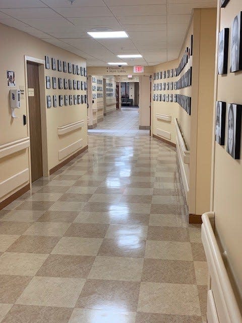 Photos of masked Portsmouth Regional Hospital employees line the hallway on the first floor of the hospital. The photo installation was designed to celebrate the contributions and commitment made by hospital staff every day to care for their patients, colleagues, and communities.