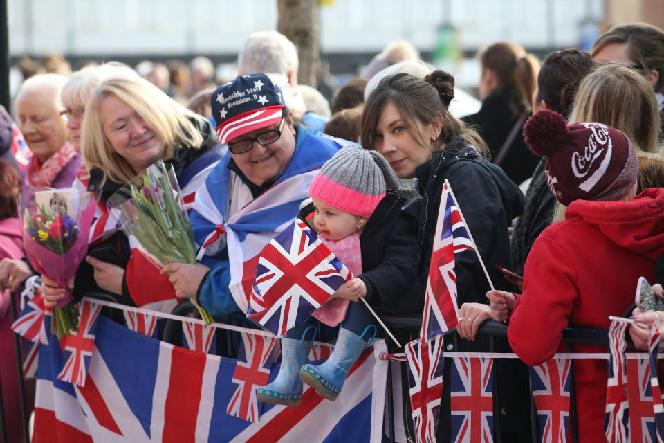 Patriotic crowds line the streets, waiting for a glimpse of the royals. (PA Images)