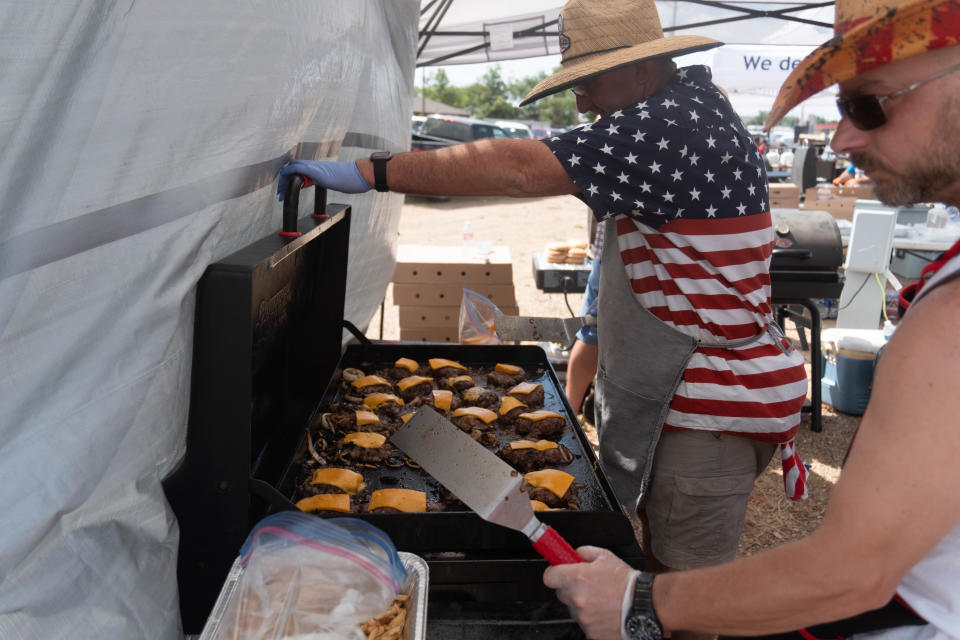 A cooking team works diligently to cook the top burger  Saturday at Friona's 17th annual Cheeseburger Festival.