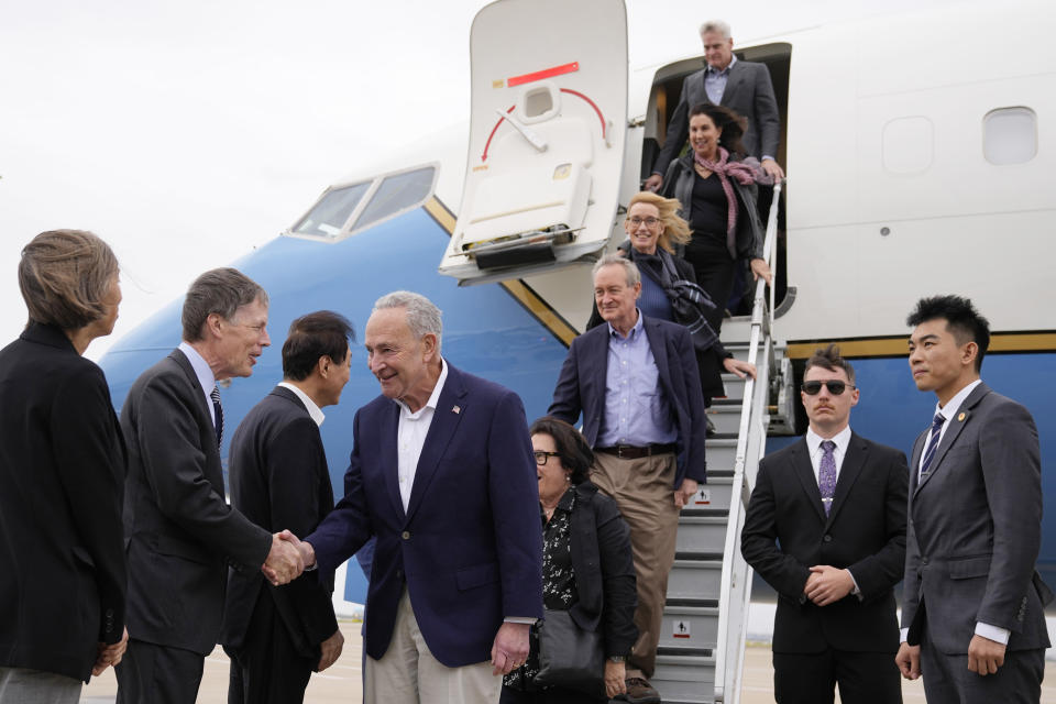 U.S. Senate Majority Leader Chuck Schumer, D-N.Y., fourth left, and other members of the delegation arrive at Shanghai Pudong International Airport in Shanghai, China, Saturday, Oct. 7, 2023. (Aly Song/Pool Photo via AP)