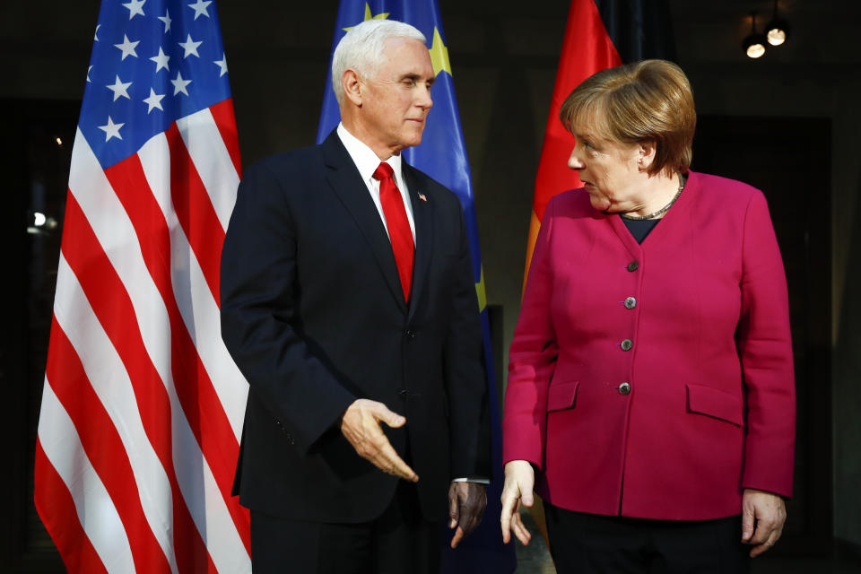 German Chancellor Angela Merkel, right, welcomes United States Vice President Mike Pence, left, for a bilateral meeting during the Munich Security Conference in Munich, Germany, Saturday, Feb. 16, 2019. (AP Photo/Matthias Schrader)