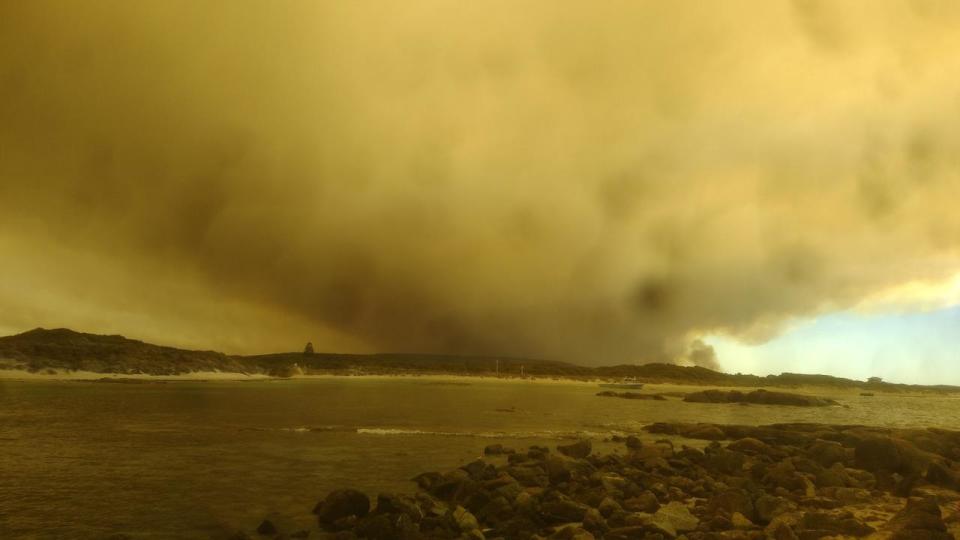 A picture of smoke from Peaceful Bay of a bushfire burning out of control at Walpole, WA. Photo: Facebook