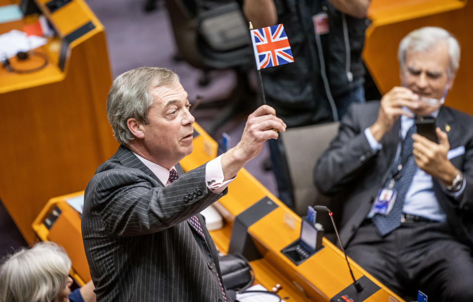 30 January 2020, Belgium, Brüssel: Nigel Farage (Brexit Party, Great Britain) waves a small flag in the plenary. Two days before Britain's withdrawal from the European Union, the European Parliament also ratified the EU withdrawal agreement at a meeting in Brussels and finally sealed the brexit. Photo: Michael Kappeler/dpa (Photo by Michael Kappeler/picture alliance via Getty Images)