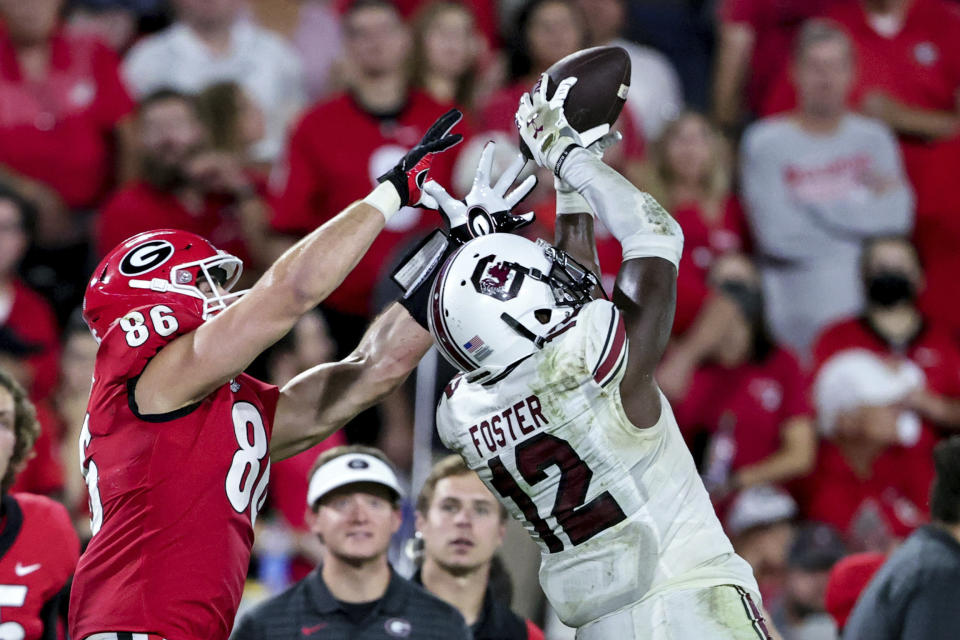 South Carolina defensive back Jaylan Foster (12) intercepts a pass intended for Georgia tight end John FitzPatrick (86) during the second half of an NCAA college football game Saturday, Sept. 18, 2021, in Athens, Ga. Georgia won 40-13. (AP Photo/Butch Dill)