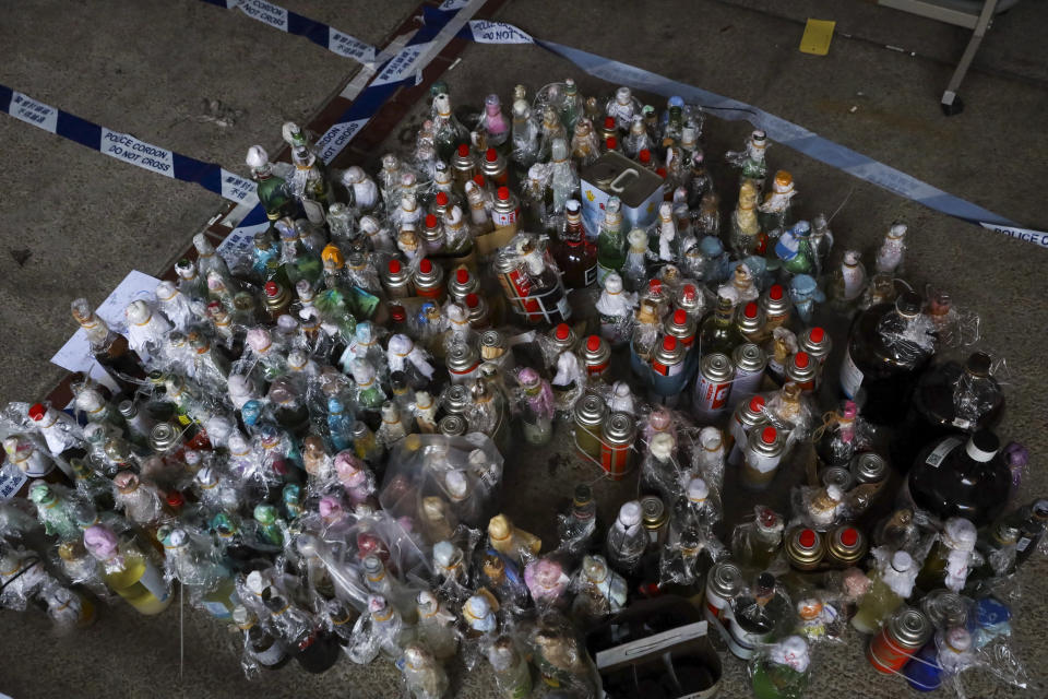 Molotov cocktails, gas canisters and flammable materials collected by police as evidence are placed in a cordoned off area as they clear the Polytechnic University campus in Hong Kong, Thursday, Nov. 28, 2019. Police safety teams Thursday began clearing a university that was a flashpoint for clashes with protesters, and an officer said any holdouts still hiding inside would not be immediately arrested. (AP Photo/Ng Han Guan)