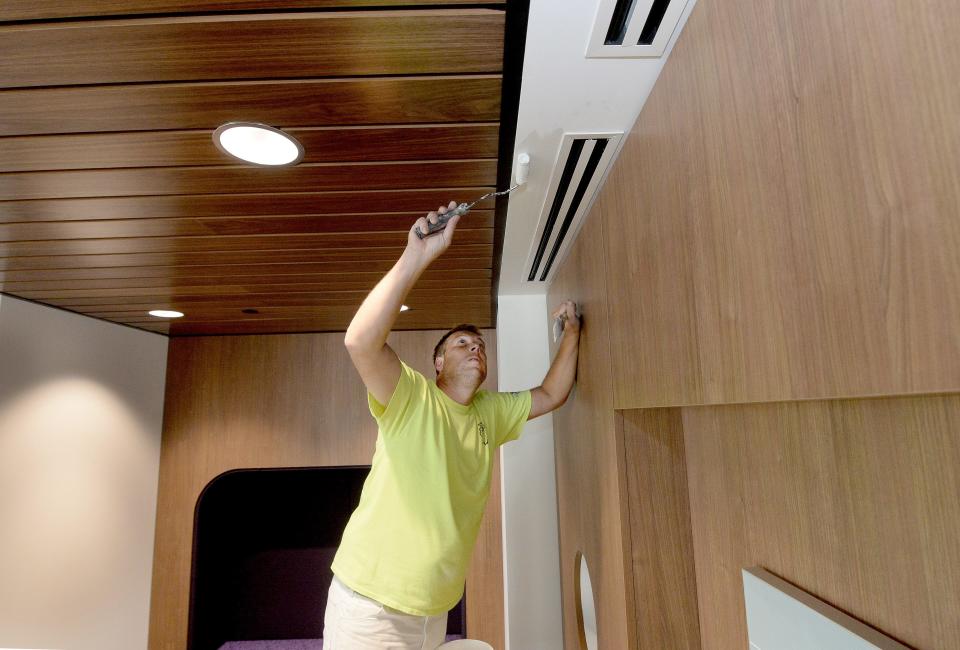 Vincent Van Ree of Springfield paints the ceiling of what they call the cozy room at the new Springfield Clinic Pediatrics Monday, Oct. 9, 2023.