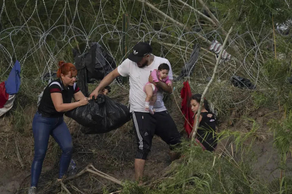 Families make the desperate effort to cross (AP)